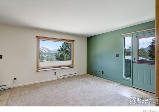 empty room featuring carpet flooring and baseboard heating