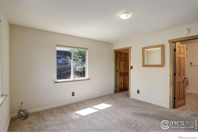 unfurnished bedroom with light colored carpet