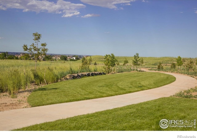 surrounding community featuring a lawn and a rural view