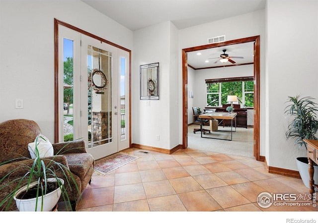 foyer featuring plenty of natural light, light tile patterned floors, and ceiling fan