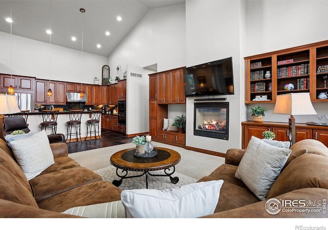 living room featuring dark wood-type flooring and high vaulted ceiling