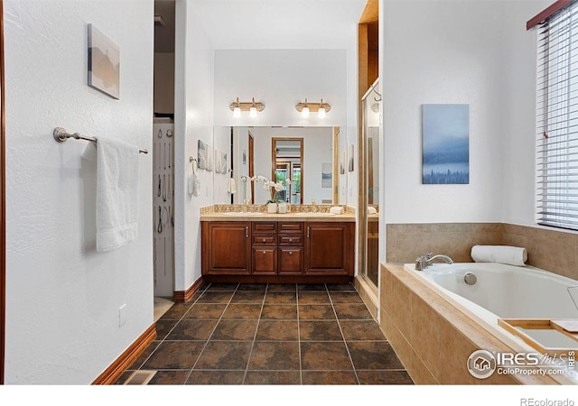 bathroom with separate shower and tub and vanity