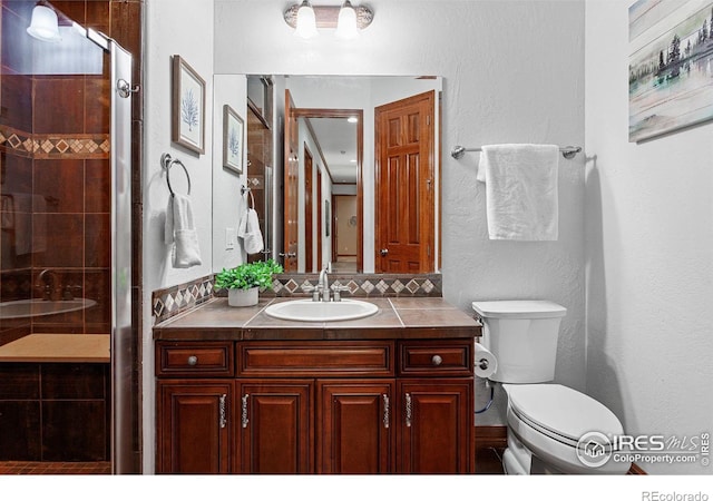 bathroom with walk in shower, toilet, and vanity