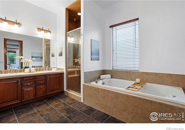 bathroom featuring vanity, independent shower and bath, and tile patterned flooring