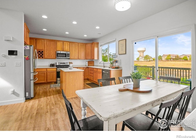 dining room with sink and light hardwood / wood-style floors