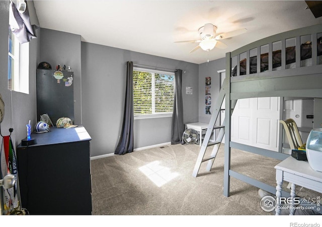 carpeted bedroom with ceiling fan and stainless steel refrigerator