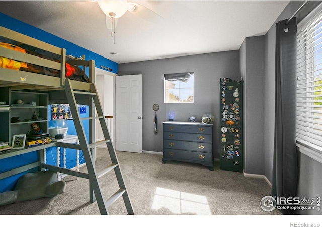 carpeted bedroom featuring ceiling fan and multiple windows