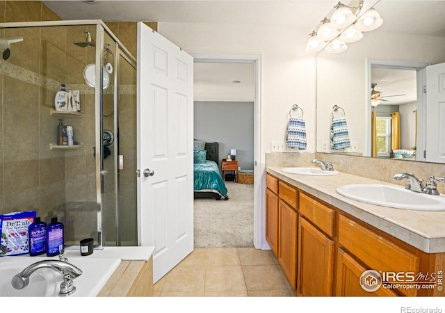 bathroom featuring vanity, ceiling fan, tile patterned floors, and plus walk in shower