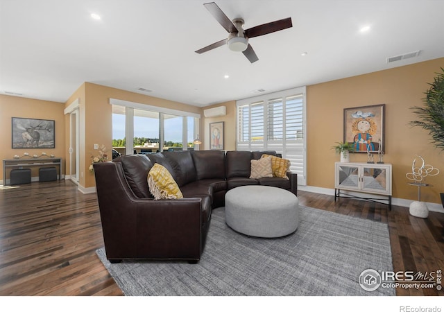 living room featuring ceiling fan, dark hardwood / wood-style floors, and a wall mounted air conditioner