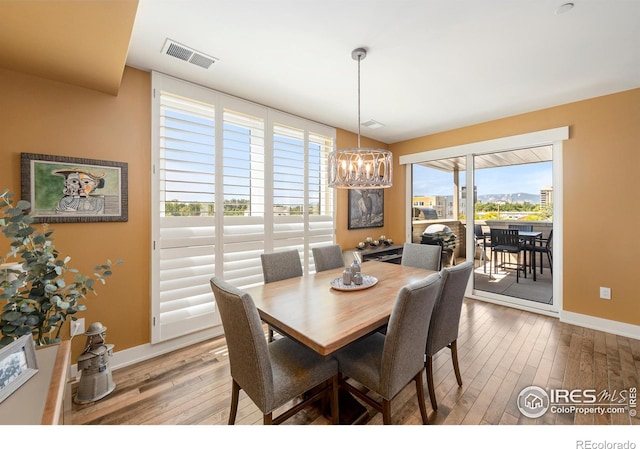 dining room with a notable chandelier and hardwood / wood-style floors