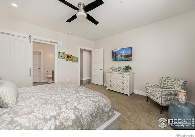 bedroom featuring carpet flooring, ensuite bathroom, ceiling fan, and a barn door