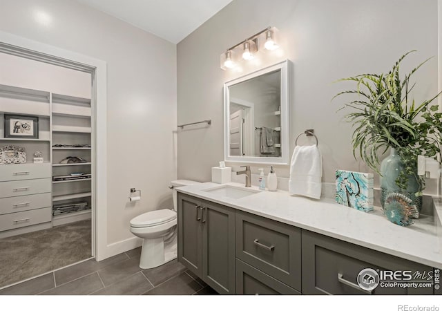 bathroom with vanity, toilet, and tile patterned floors