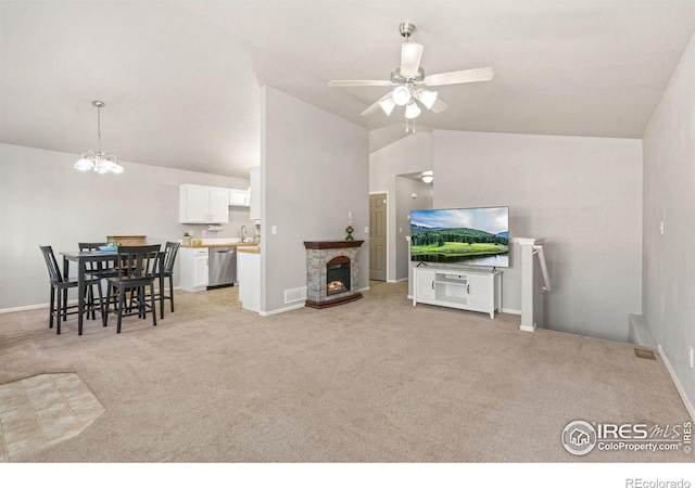 interior space with ceiling fan with notable chandelier, lofted ceiling, sink, and light colored carpet