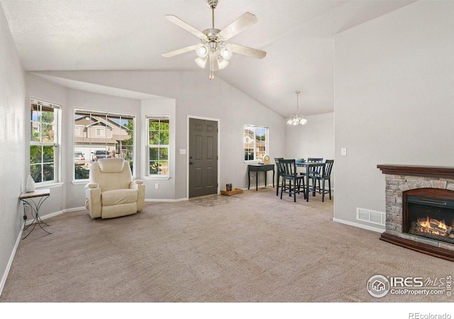 living area featuring lofted ceiling, carpet, ceiling fan, and a fireplace