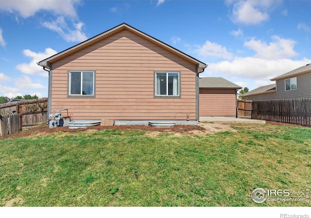 rear view of house featuring a lawn