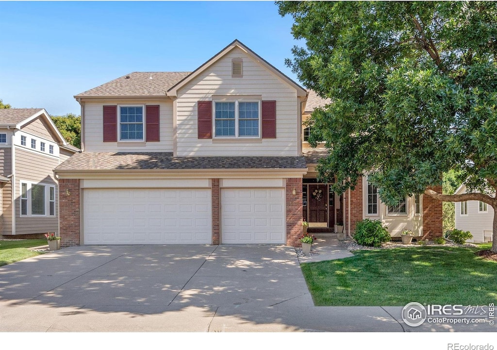 view of property with a front yard and a garage