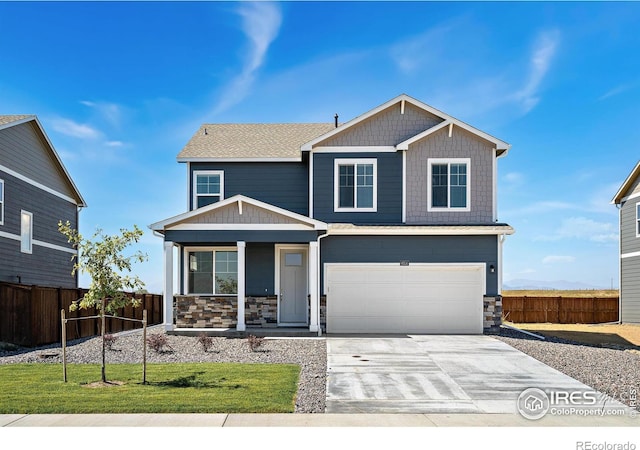 craftsman-style house featuring a garage, a front yard, and covered porch