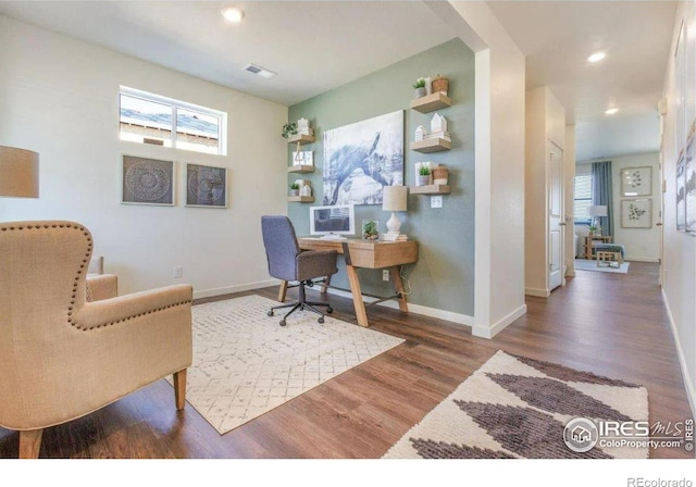 home office with dark hardwood / wood-style flooring