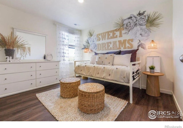 bedroom featuring dark wood-type flooring