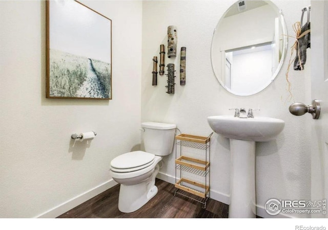 bathroom featuring toilet and wood-type flooring