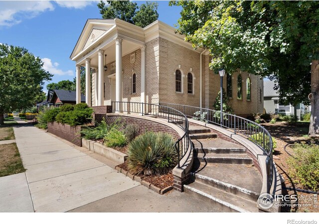 greek revival inspired property with a porch