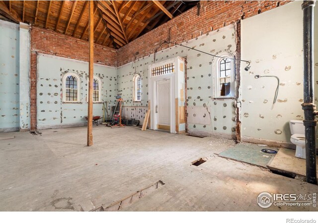 miscellaneous room featuring high vaulted ceiling