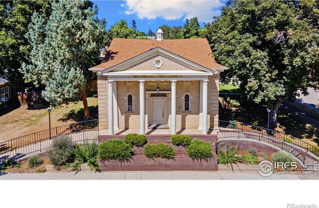 neoclassical / greek revival house featuring covered porch