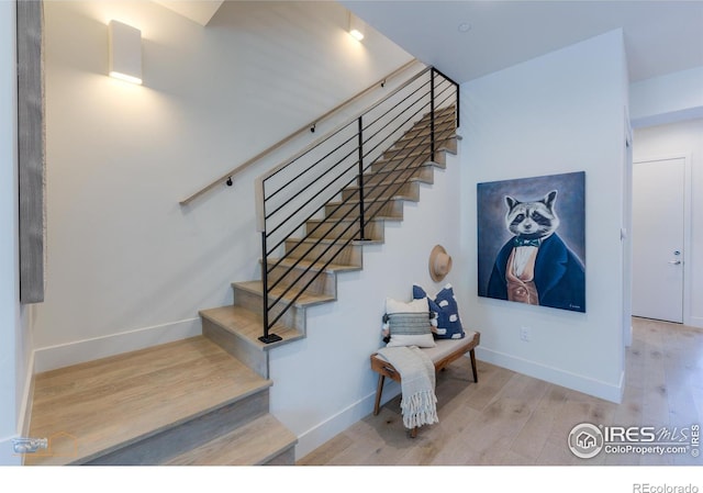 stairway featuring wood-type flooring