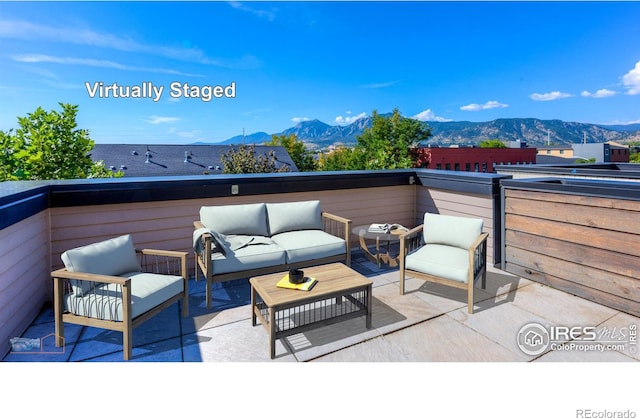 deck featuring a mountain view, an outdoor hangout area, and a patio area