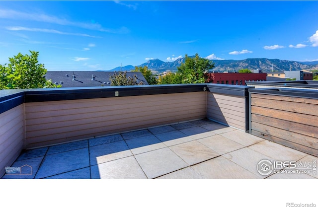 view of patio / terrace with a mountain view and a balcony