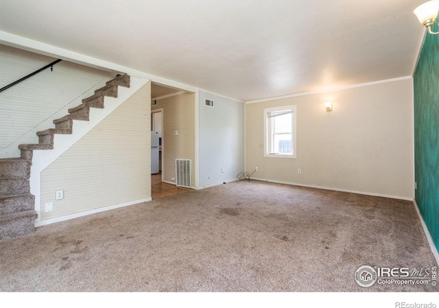 unfurnished living room with ornamental molding and carpet floors