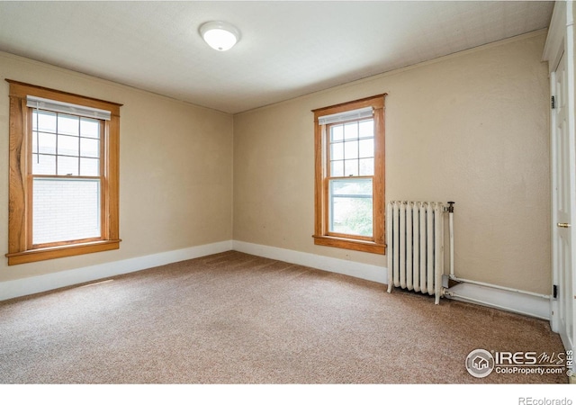 unfurnished room with carpet flooring and radiator heating unit