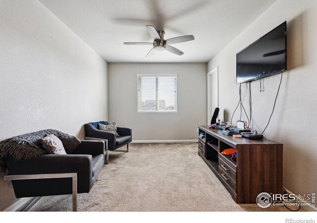 living area with ceiling fan and light carpet