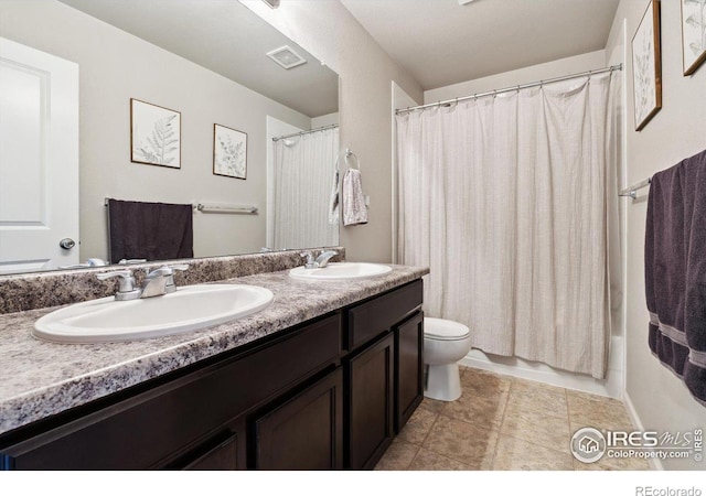 full bathroom featuring shower / bath combination with curtain, vanity, and toilet