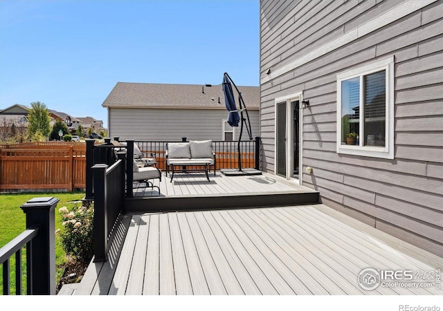 wooden terrace with an outdoor living space