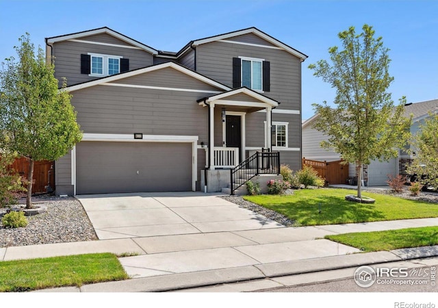 view of front of house with a front yard and a garage