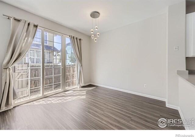 unfurnished dining area featuring dark wood-type flooring