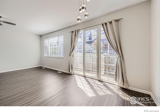 spare room featuring ceiling fan and dark wood-type flooring