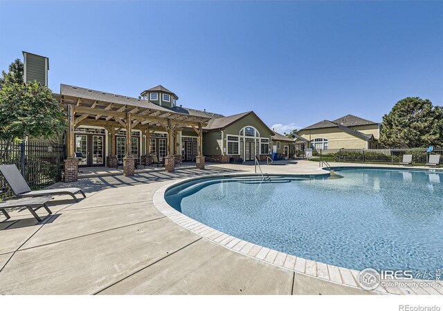 view of swimming pool featuring a patio and a pergola