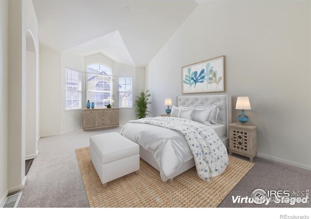 carpeted bedroom featuring high vaulted ceiling