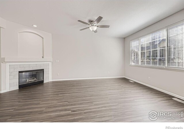 unfurnished living room with ceiling fan and dark hardwood / wood-style floors