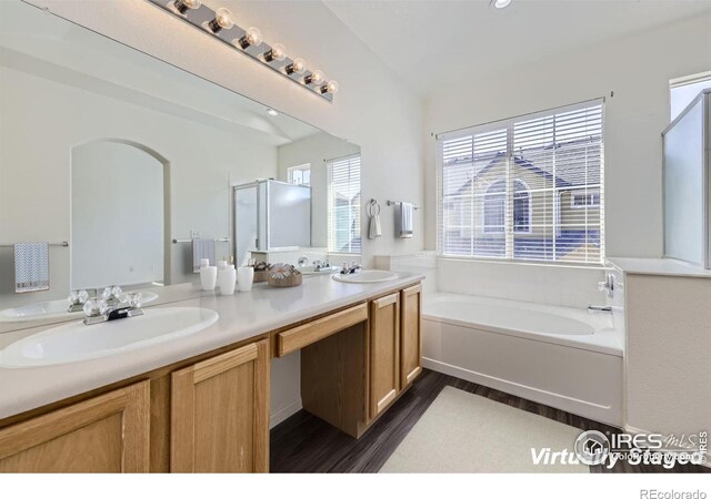 bathroom featuring shower with separate bathtub, vanity, and hardwood / wood-style flooring