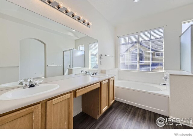 bathroom with shower with separate bathtub, vanity, and hardwood / wood-style floors