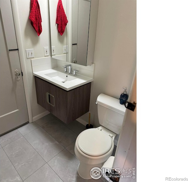 bathroom featuring vanity, toilet, and tile patterned flooring