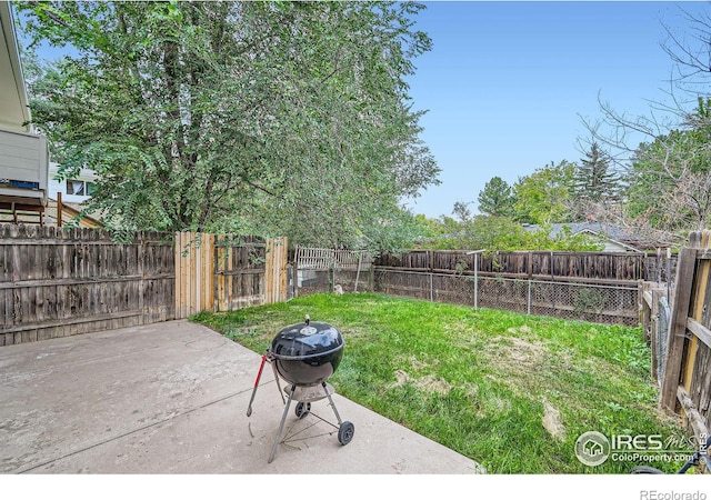 view of yard featuring a fire pit and a patio