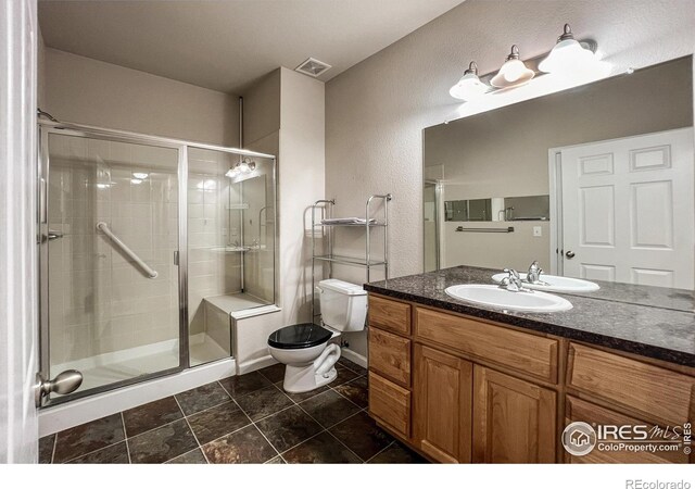 bathroom with vanity, toilet, and walk in shower