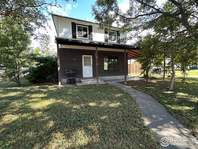 view of front of house featuring covered porch and a front yard