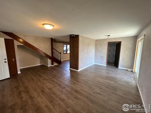 601 E 2nd St, Akron, CO 80720 - unfurnished living room featuring stairs, wood finished floors, and baseboards