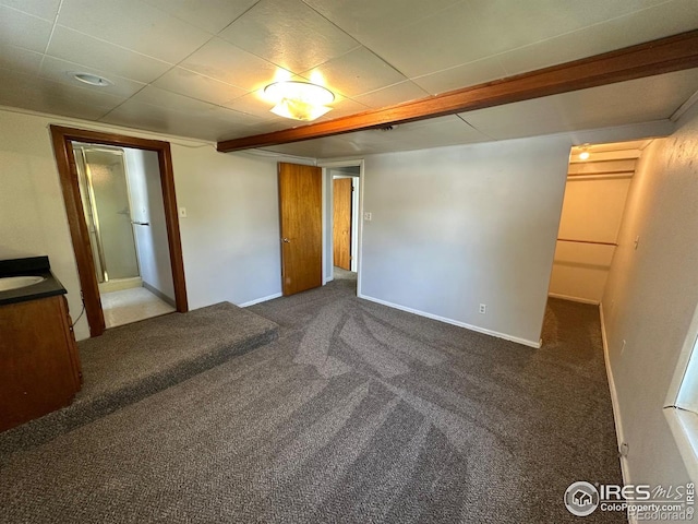 unfurnished bedroom with dark carpet