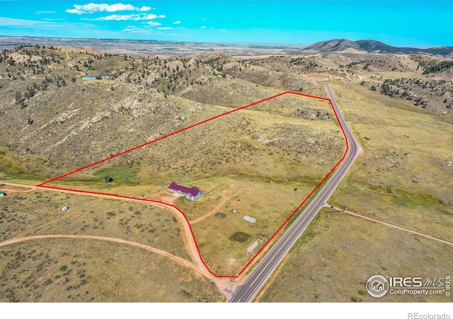 drone / aerial view featuring a rural view and a mountain view